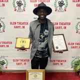 Aaron Davis holding various film awards