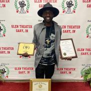 Aaron Davis holding various film awards